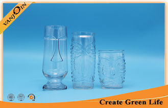 China 600ml Tiki Relief Clear Glass Beverage Bottles With Glass Stand supplier